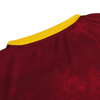 Close-up of the upper back of the West Indies cricket jersey, highlighting the maroon fabric texture and detailed stitching.