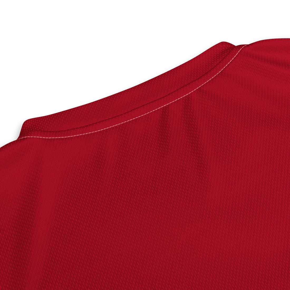 Close-up view of the upper back of the England cricket jersey showing the vibrant red fabric texture.