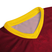 Close-up view of the V-neck collar of the West Indies cricket jersey, showing the yellow trim against the maroon fabric.