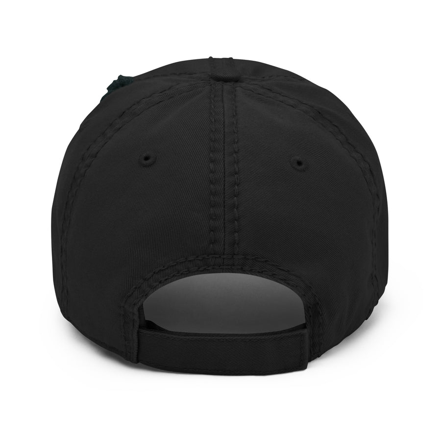 Back view of a distressed black dad hat with an adjustable strap, highlighting the frayed stitching and rugged texture.