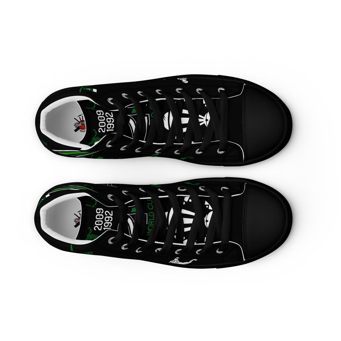 Top view of a pair of black high-top canvas shoes with green accents and white laces, showcasing the words &