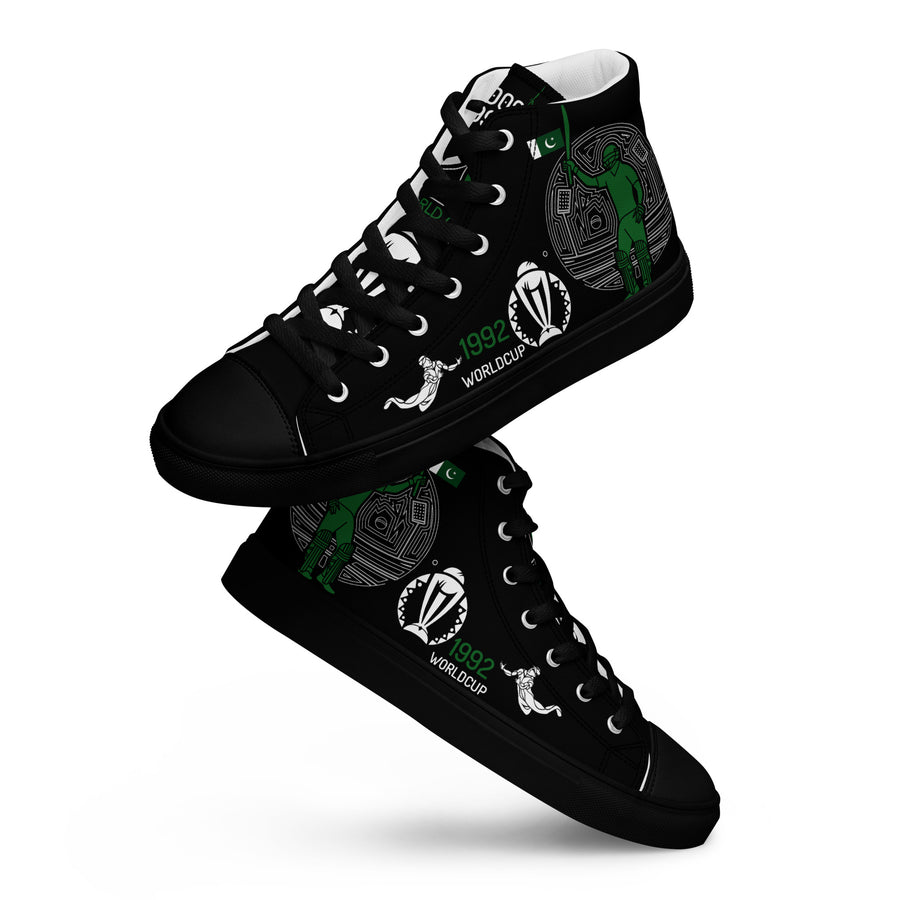 A pair of men's high-top canvas sneakers with a black sole and design elements celebrating Pakistan's cricket achievements. The shoes feature the text "1992 World Cup" and cricket imagery in white and green on a black background, reflecting the colors of the Pakistani flag.