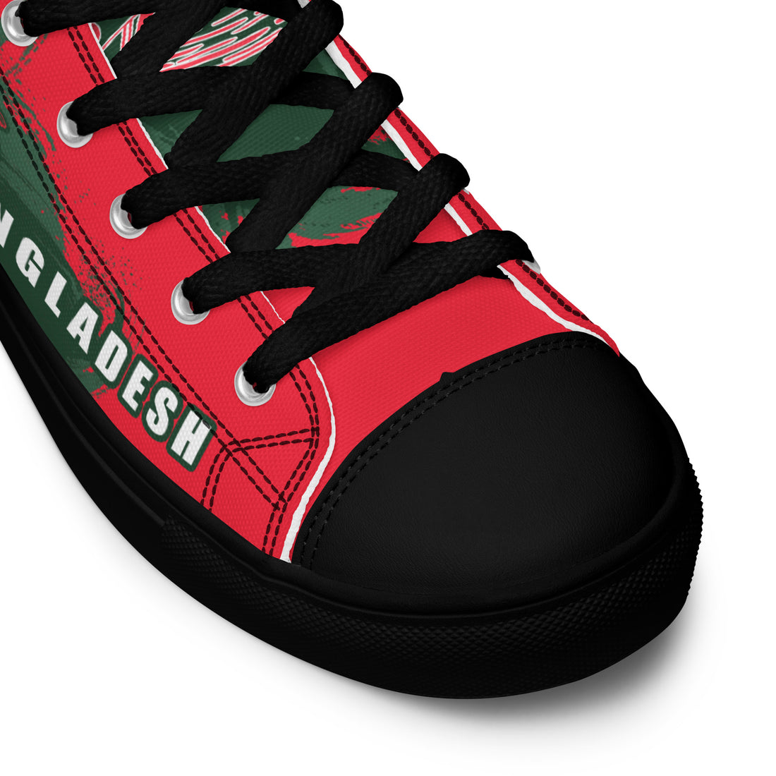 Close-up of the front of a Bat Ball Wicket sneaker with black laces over a red canvas, a black toe cap, and the word &