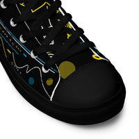 Close-up view focusing on the toe cap of men's high-top canvas shoes, showing the detailed cricket equipment graphics in yellow, blue, and white on a black fabric.