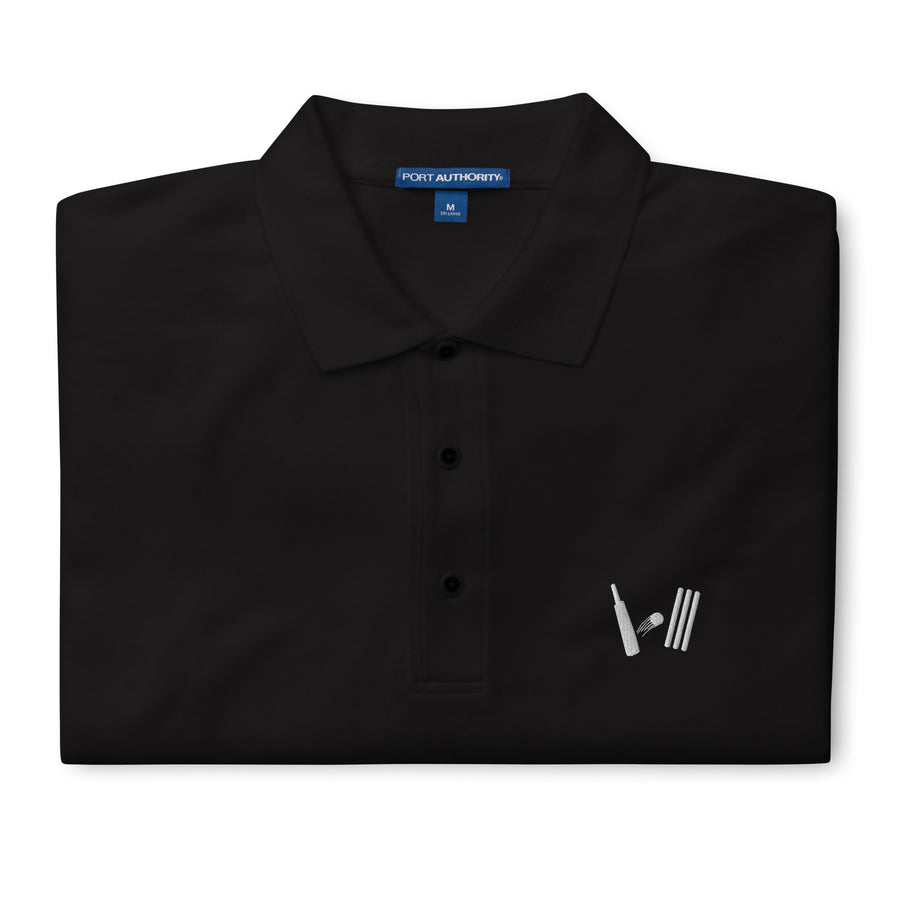 Elegant black polo shirt displayed flat, highlighting the embroidered cricket logo on the left chest and a Port Authority tag on the collar