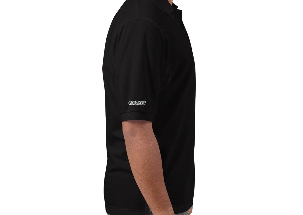 Side view of a man wearing a black polo shirt, showing the &