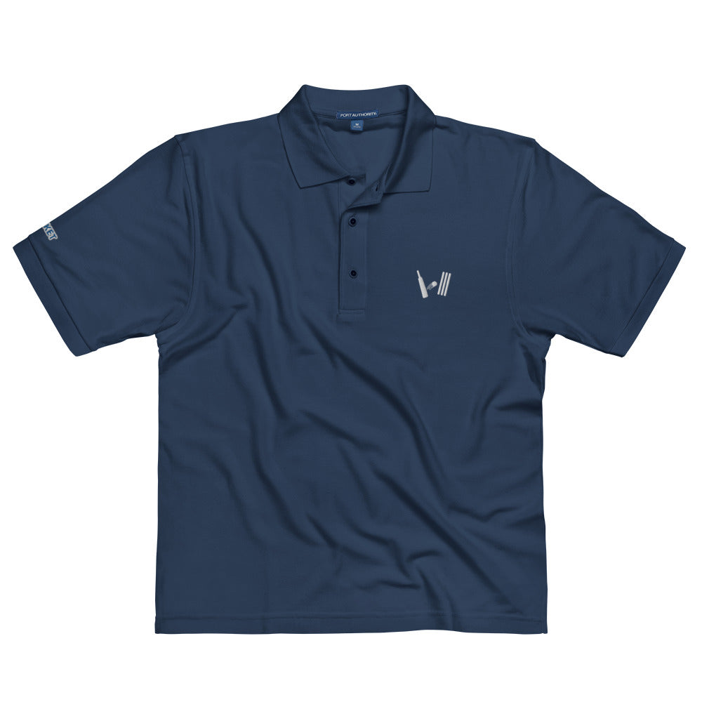 Front view of a navy blue polo shirt lying flat, showcasing an embroidered cricket-themed logo on the left chest and a manufacturer&