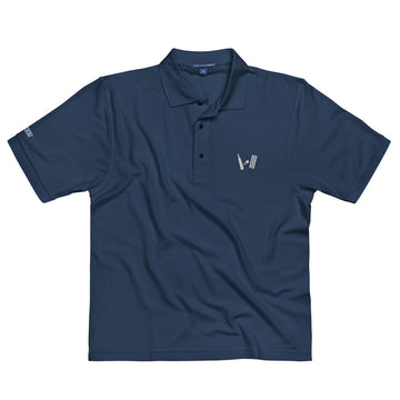 Front view of a navy blue polo shirt lying flat, showcasing an embroidered cricket-themed logo on the left chest and a manufacturer's logo on the left sleeve.