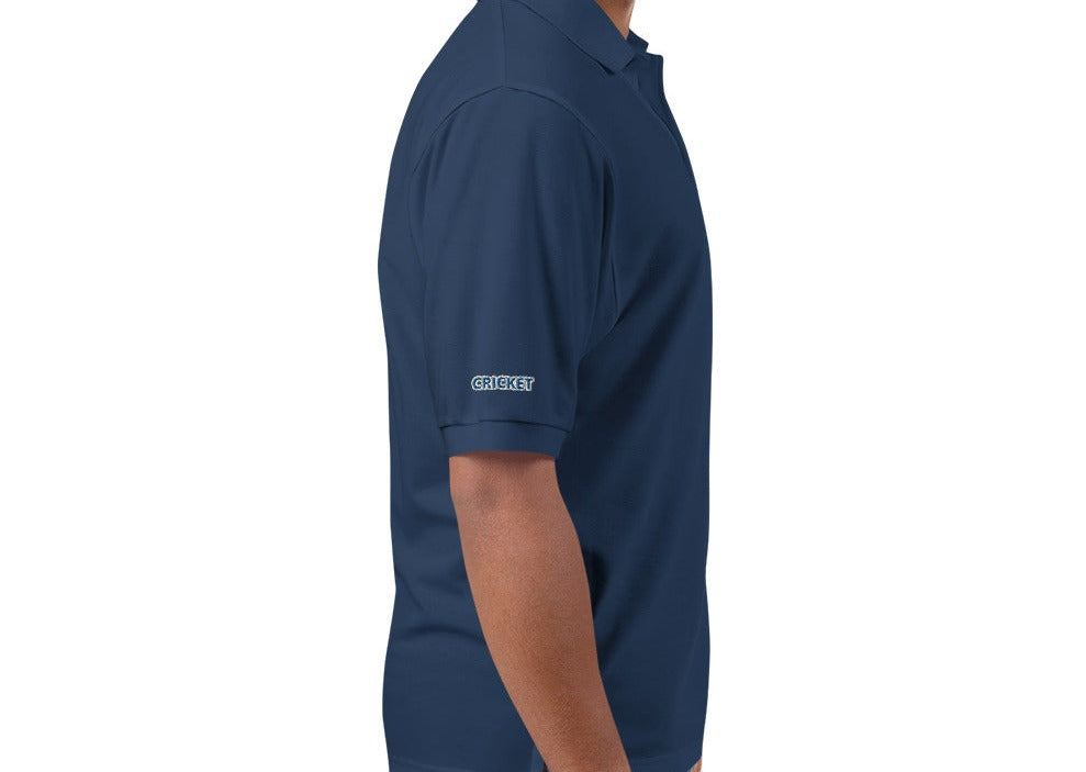 Side view of a man wearing a navy blue polo shirt, displaying the &