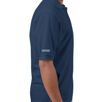 Side view of a man wearing a navy blue polo shirt, displaying the 'CRICKET' embroidery on the right sleeve, suitable for casual wear or sporting events.