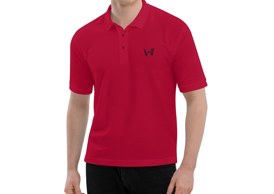 Man in a bright red polo shirt with the Bat Ball Wicket logo on the chest, ready for a stylish day on the cricket field.