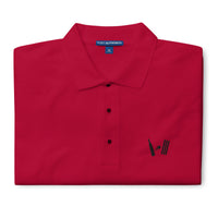 Vibrant red polo shirt folded neatly with the Bat Ball Wicket logo visible on the front, representing a bold cricket fashion statement