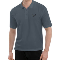 "Man wearing a steel grey polo shirt with the Bat Ball Wicket logo on the left chest, representing a sleek cricket lifestyle brand