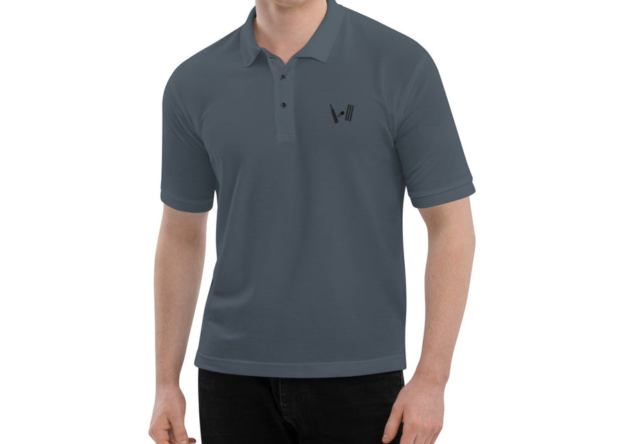 "Man wearing a steel grey polo shirt with the Bat Ball Wicket logo on the left chest, representing a sleek cricket lifestyle brand