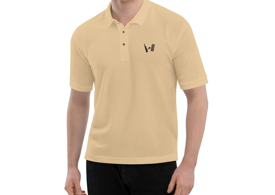 Model wearing a beige polo shirt with the Bat Ball Wicket logo embroidered on the left chest, representing a stylish cricket lifestyle