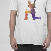 Video of a white t-shirt displaying a vibrant watercolor-style cricket player graphic, set against a plain background.