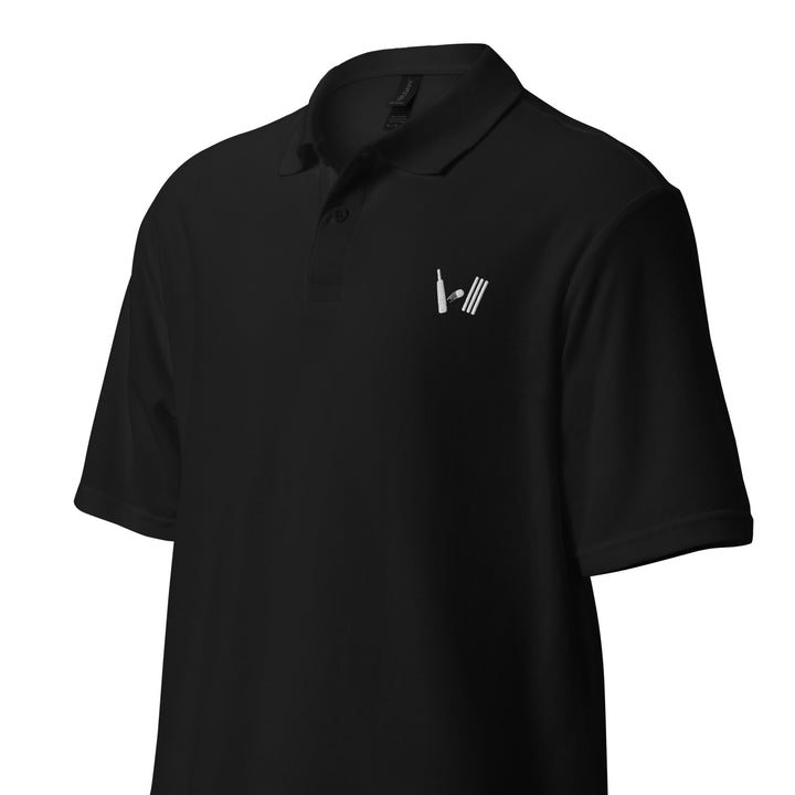 Black polo shirt laid flat, highlighting the cricket-themed embroidery on the left chest, ideal for any sports enthusiast.